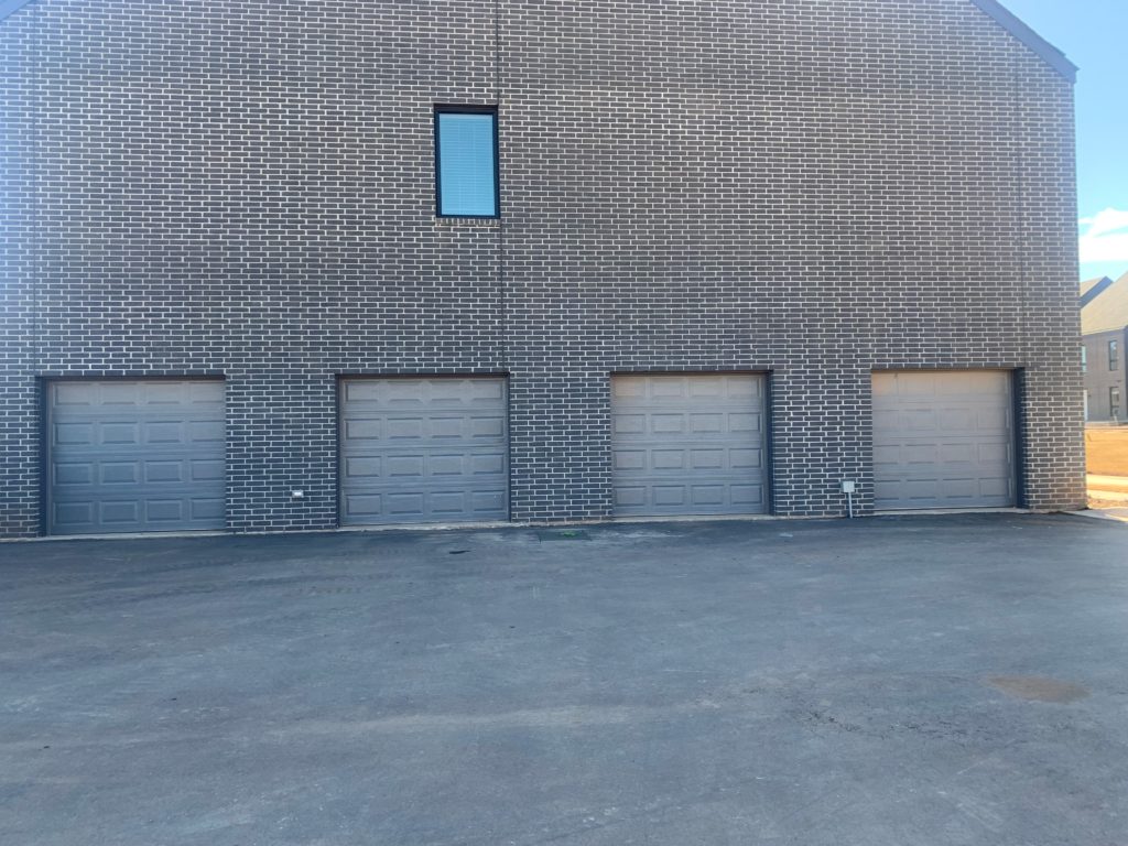 Garage entrance of Liberty Creek Village displaying 4 garage parking spots.